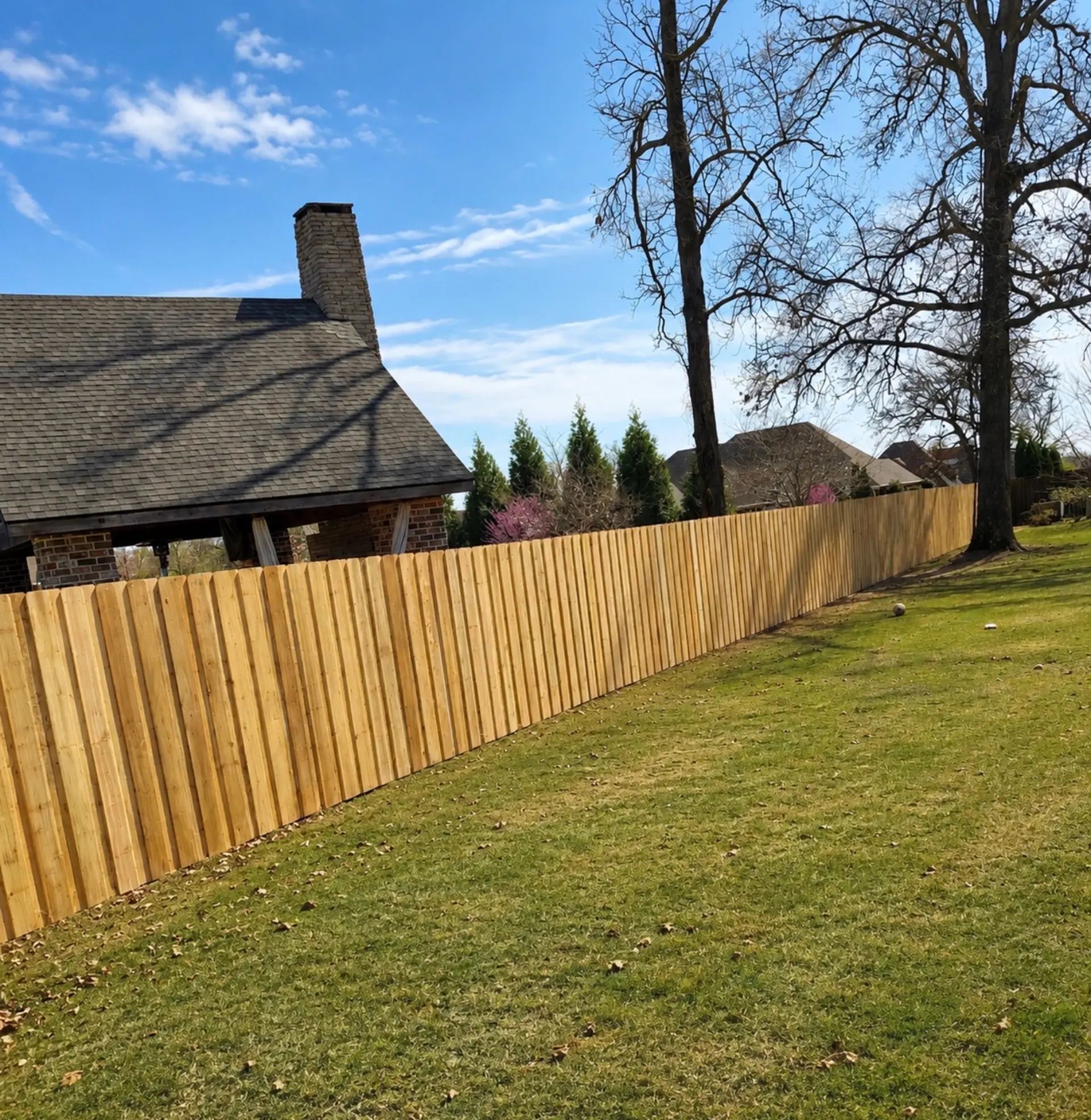 Cedar board on board privacy fence with layered overlapping pickets for airtight privacy and a dimensional finished face.